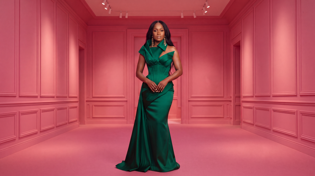 Glam Fab archetype: woman in emerald sculptural satin gown in a rose couture atelier — WifeLife.vip